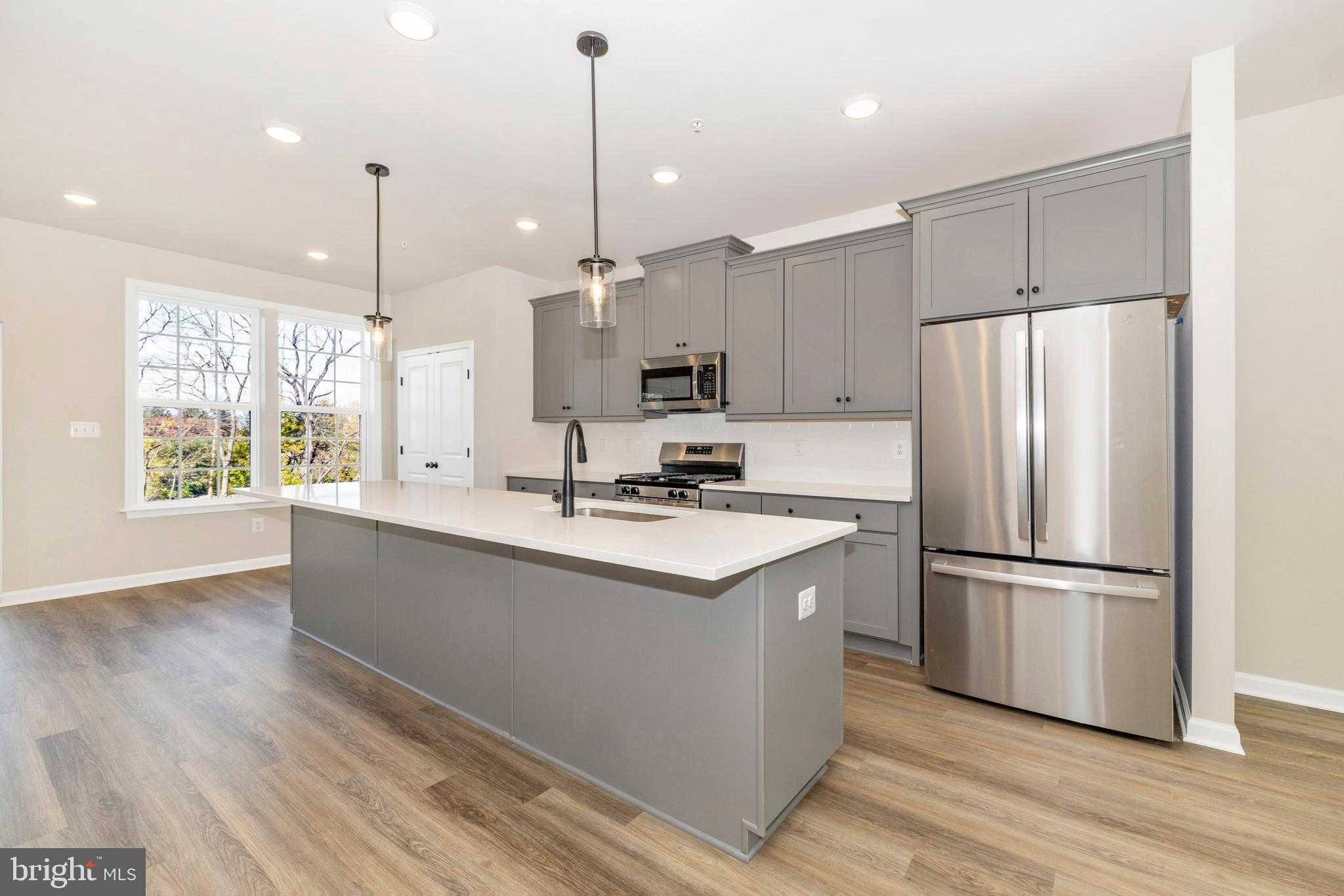 103 Spring Bank Way Frederick, MD 21701 - Photo 6 of 13 a kitchen with stainless steel appliances granite countertop a refrigerator a sink dishwasher a stove and a wooden floors