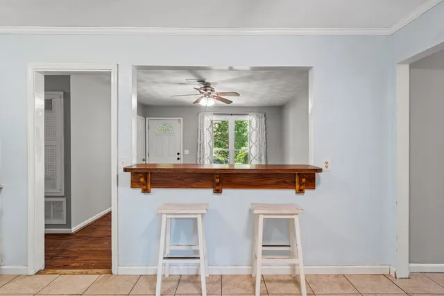 a view of a hallway with a window and wooden floor
