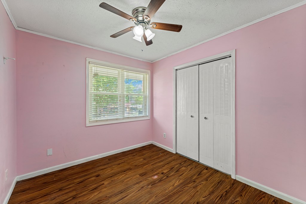 5422 Colony Drive Columbus, GA 31909 - Photo 17 of 32 a view of empty room with wooden floor and fan