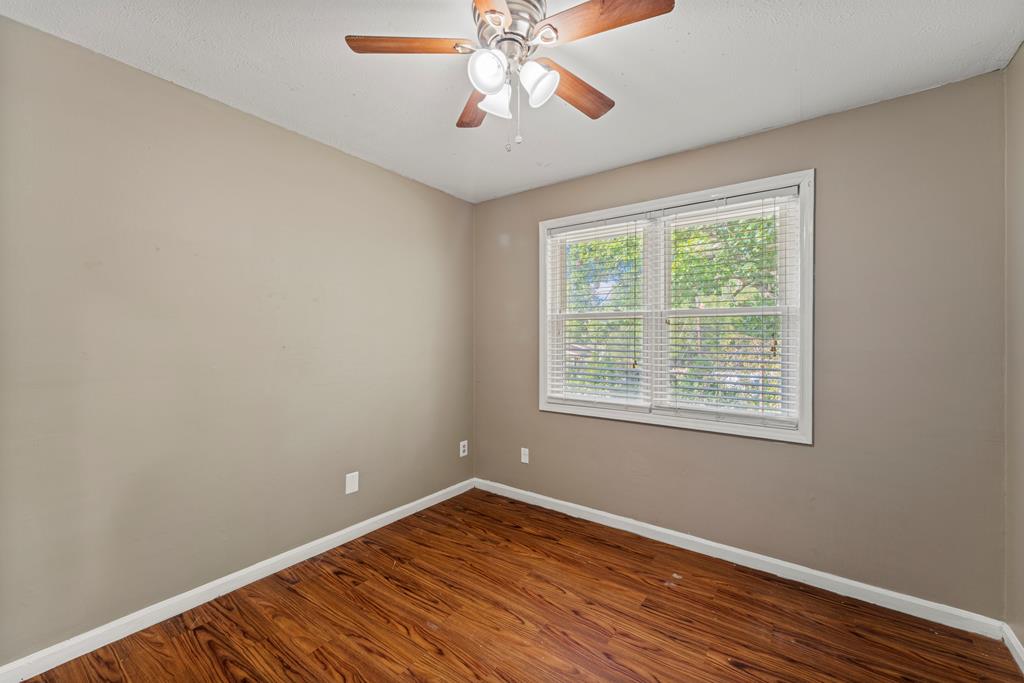 5422 Colony Drive Columbus, GA 31909 - Photo 21 of 32 a view of an empty room with wooden floor and a window