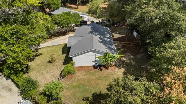 an aerial view of a house with a yard