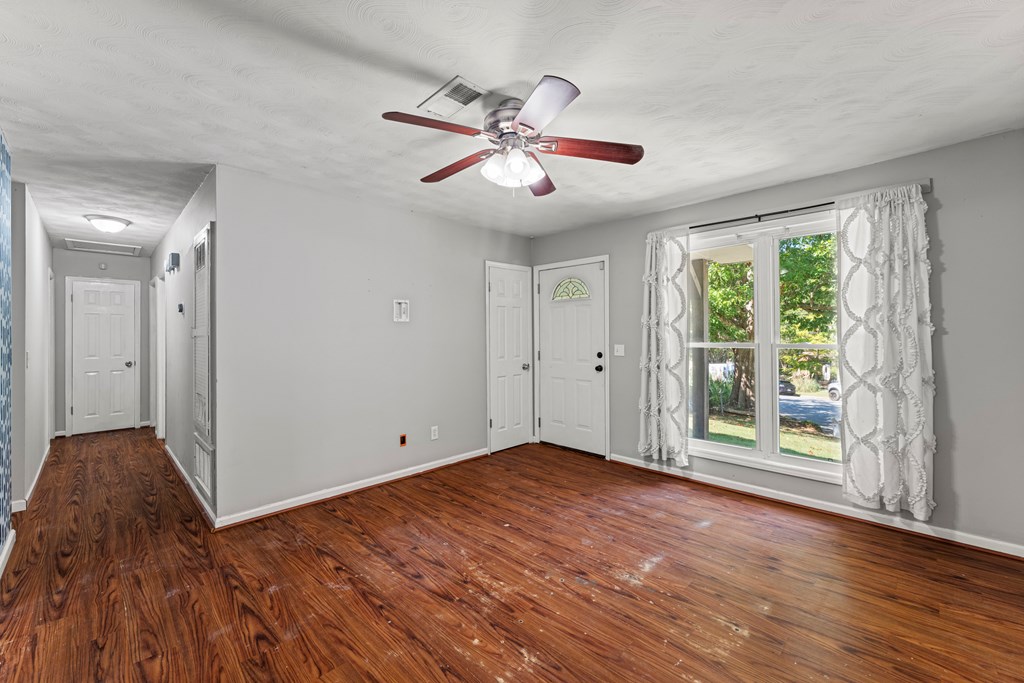 5422 Colony Drive Columbus, GA 31909 - Photo 5 of 32 a view of an empty room with wooden floor and a window