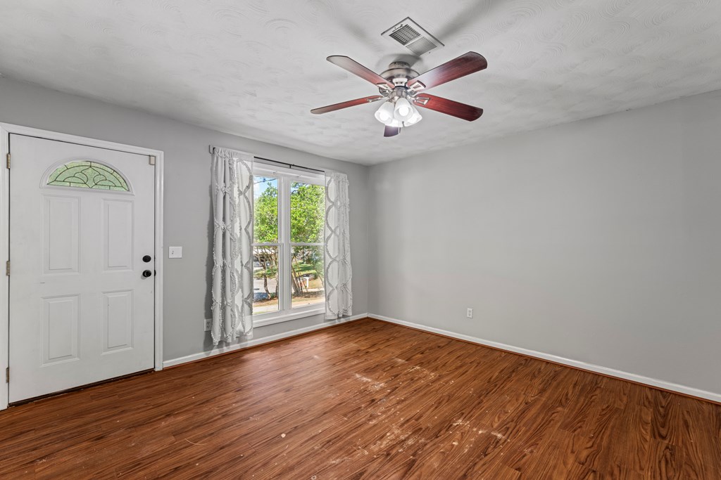 5422 Colony Drive Columbus, GA 31909 - Photo 6 of 32 a view of an empty room with wooden floor and a window