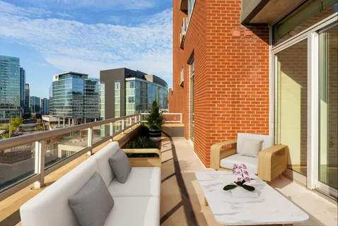 a view of balcony with couch and chairs