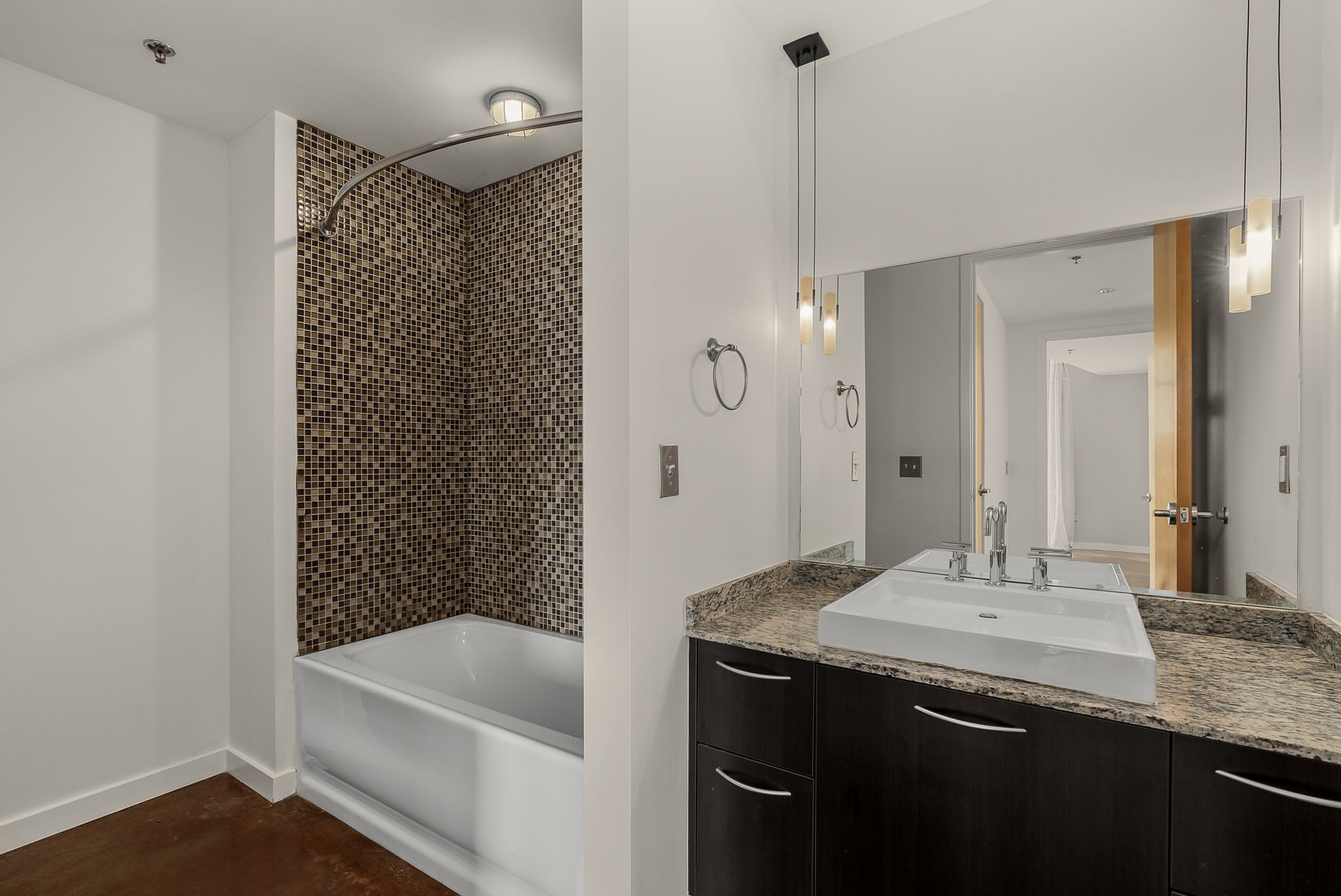 600 12th Avenue South, Unit 829 Nashville, TN 37203 - Photo 14 of 32 a bathroom with a granite countertop sink a toilet and shower