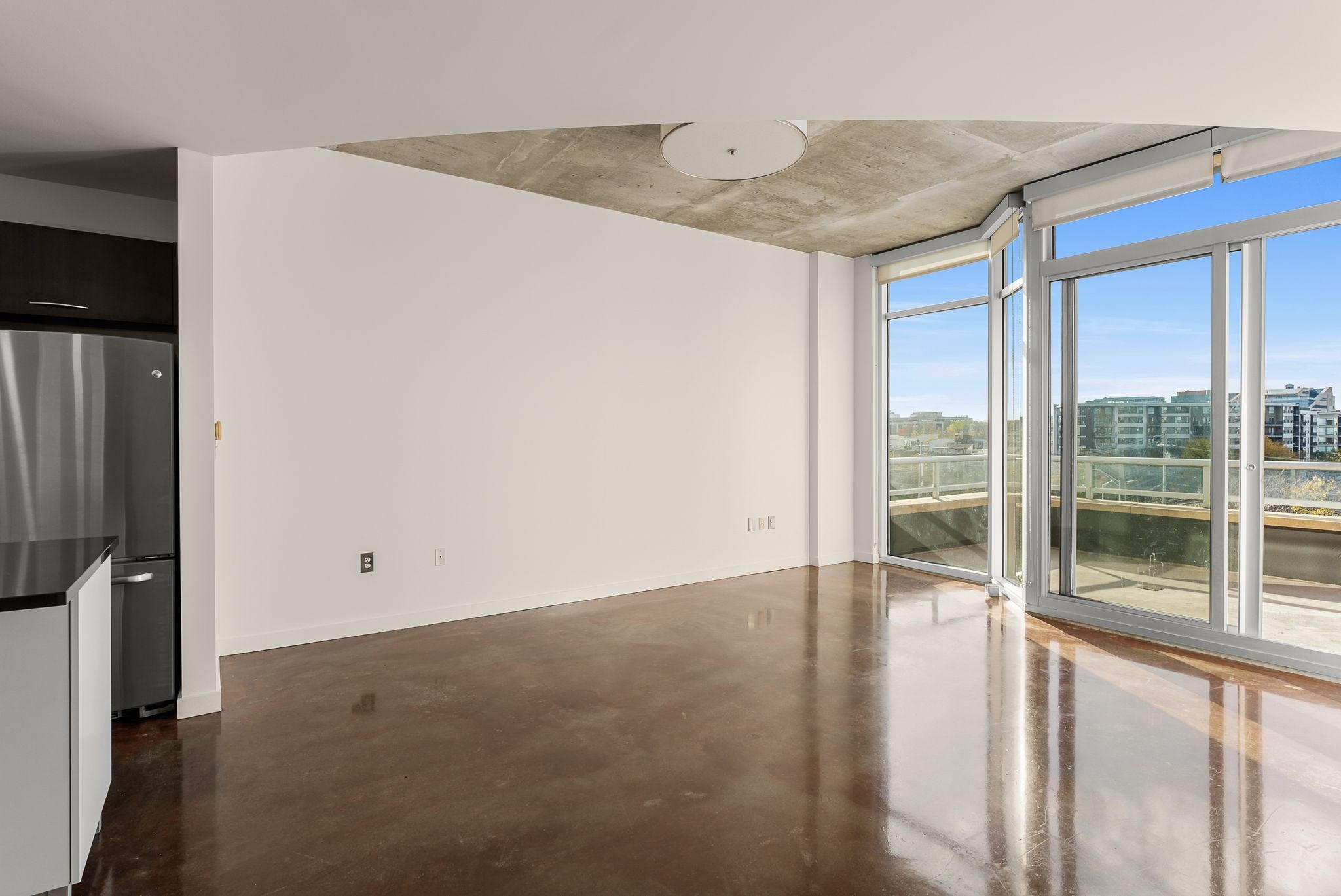 600 12th Avenue South, Unit 829 Nashville, TN 37203 - Photo 4 of 32 an empty room with wooden floor and windows