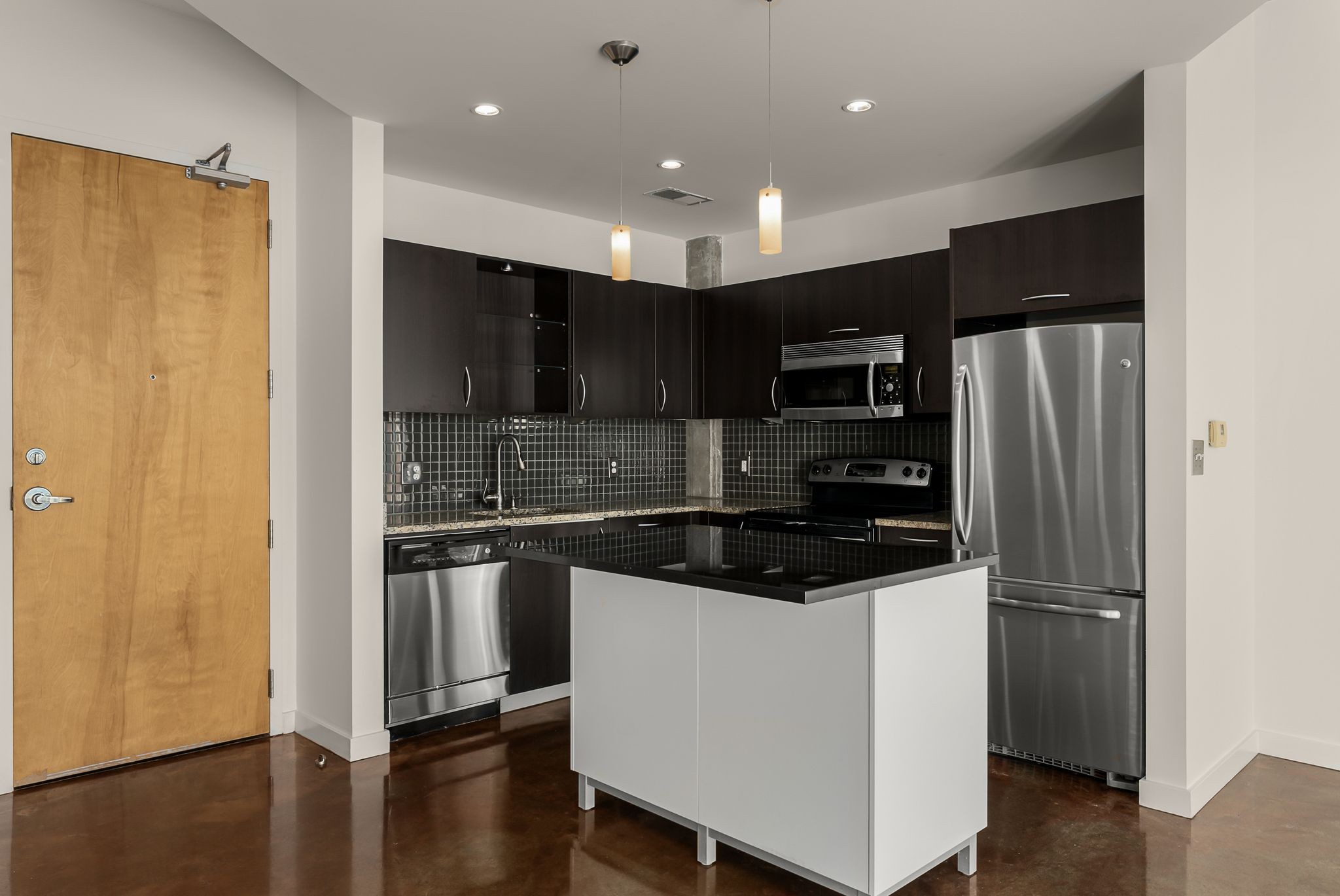600 12th Avenue South, Unit 829 Nashville, TN 37203 - Photo 7 of 32 a kitchen with stainless steel appliances granite countertop a refrigerator and a stove top oven