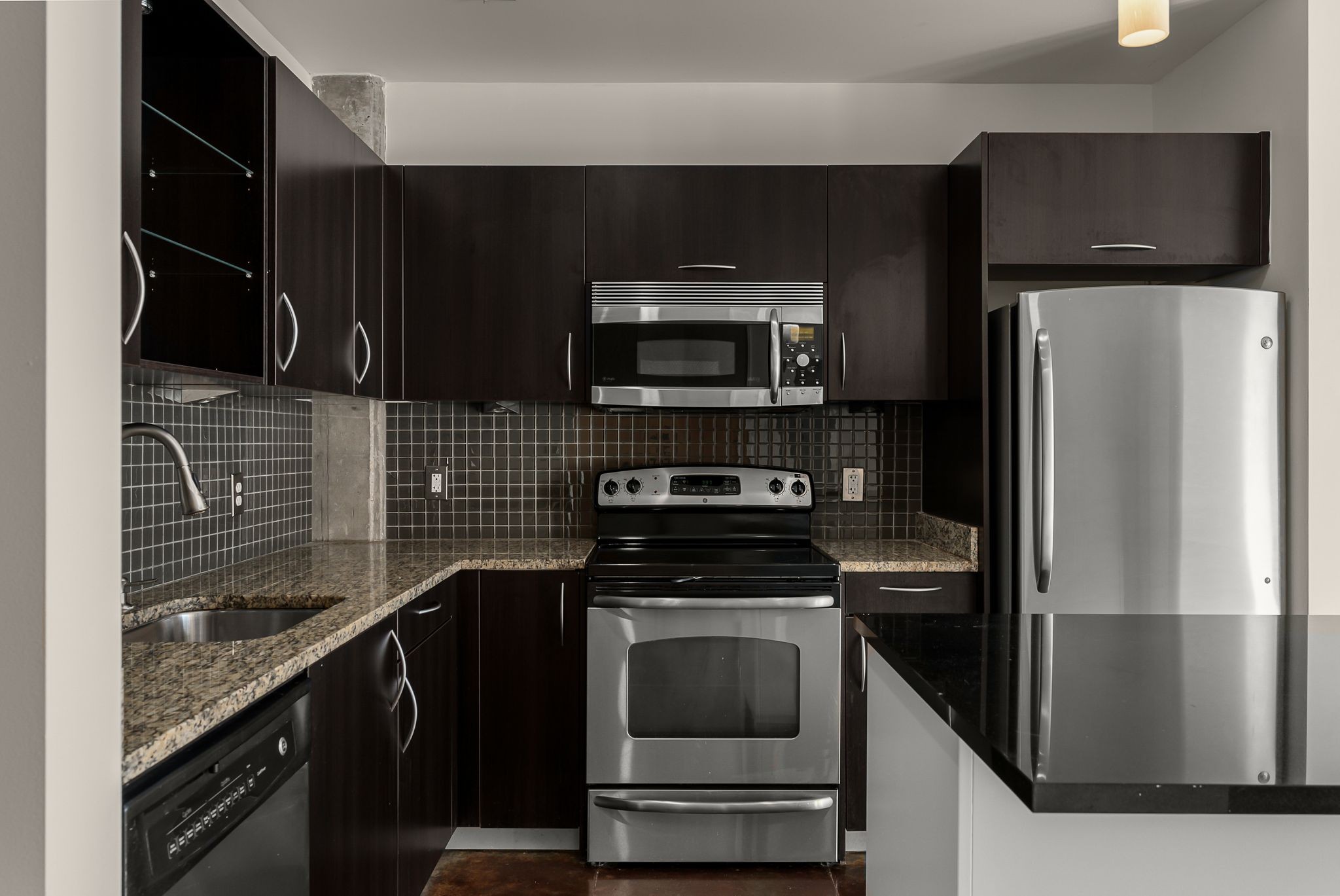 600 12th Avenue South, Unit 829 Nashville, TN 37203 - Photo 8 of 32 a kitchen with a refrigerator stove and microwave