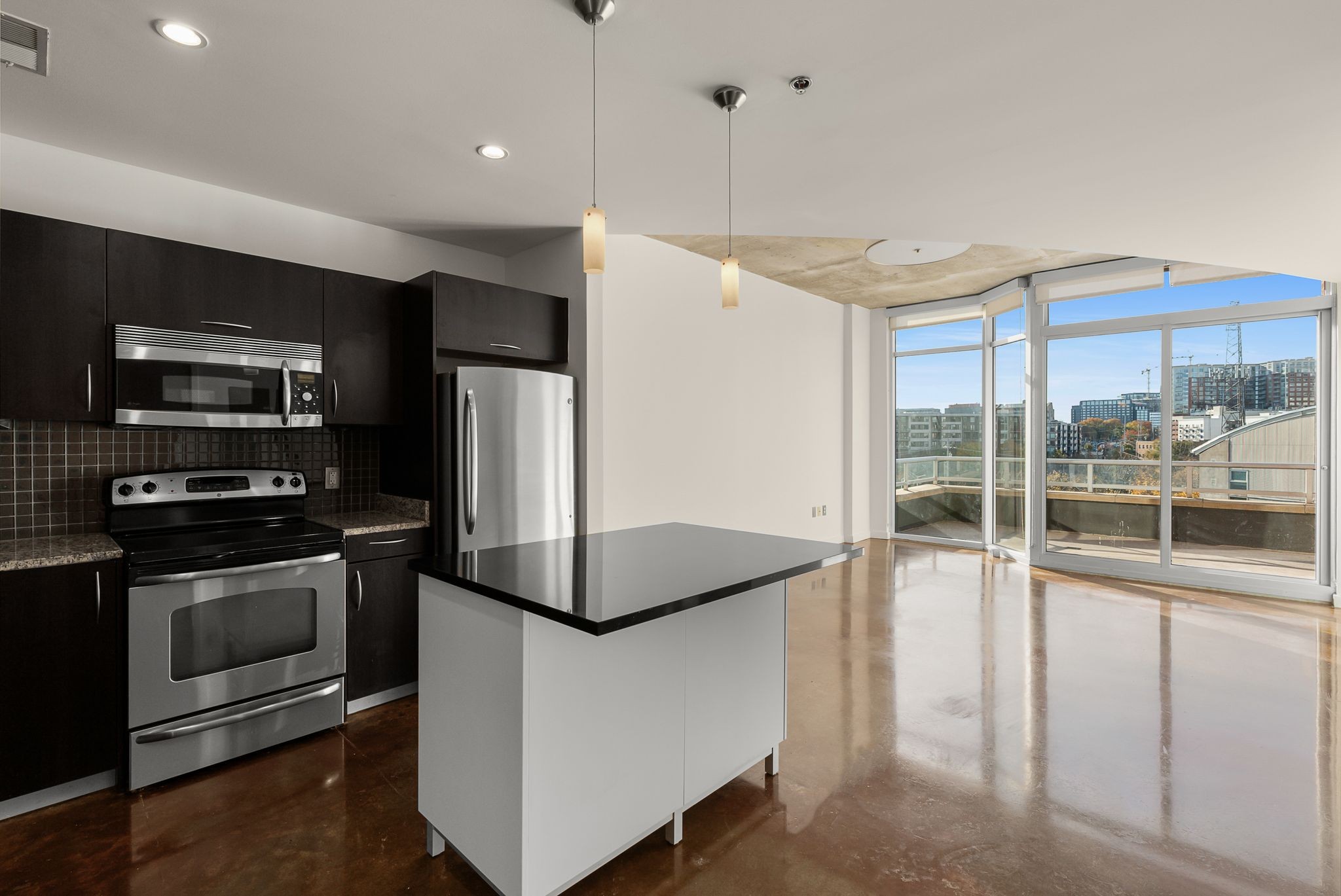 600 12th Avenue South, Unit 829 Nashville, TN 37203 - Photo 9 of 32 a kitchen with stainless steel appliances granite countertop a refrigerator and a sink