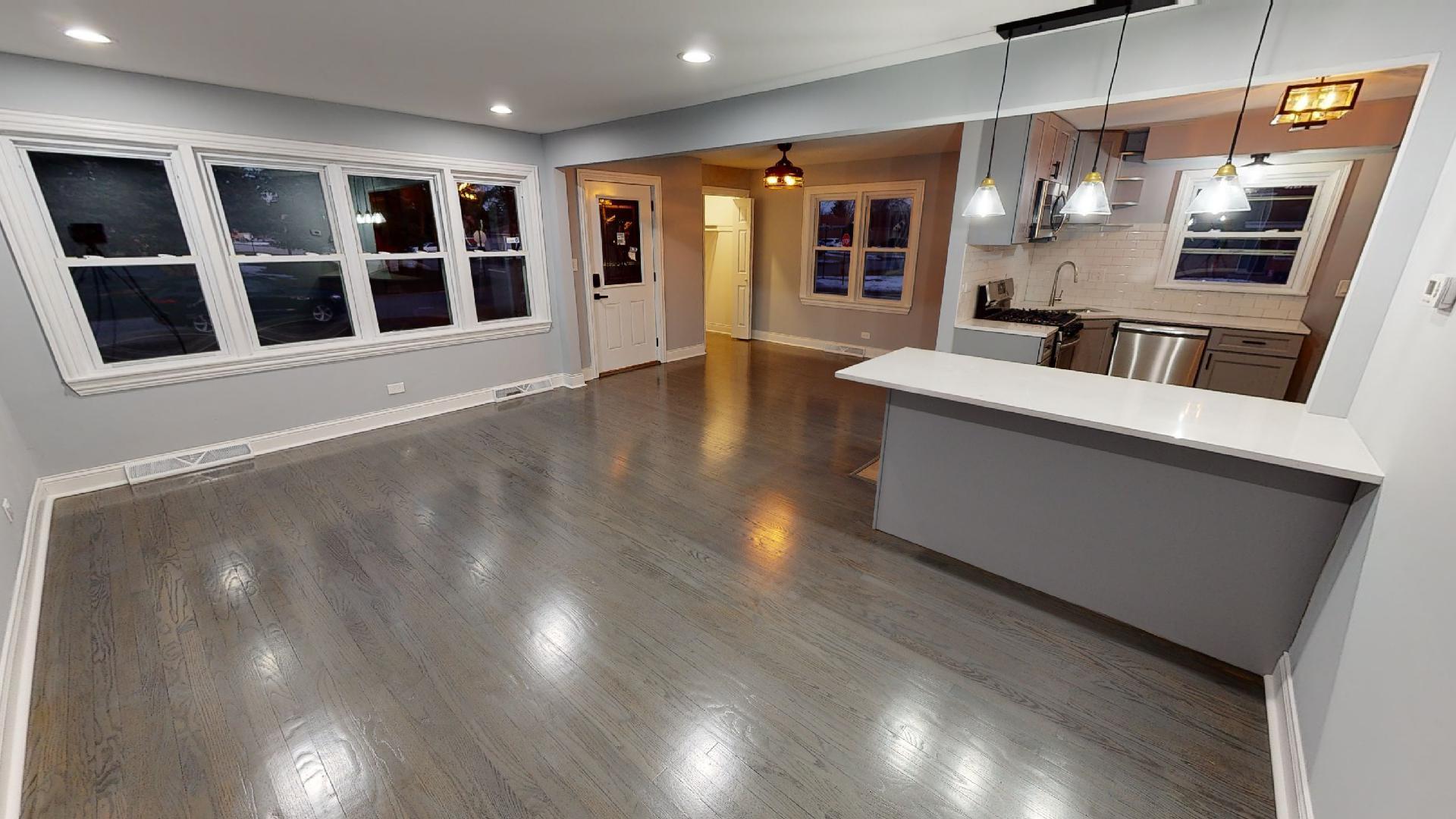 526 High Ridge Road Hillside, IL 60162 - Photo 2 of 19 a view of an empty room with wooden floor and windows
