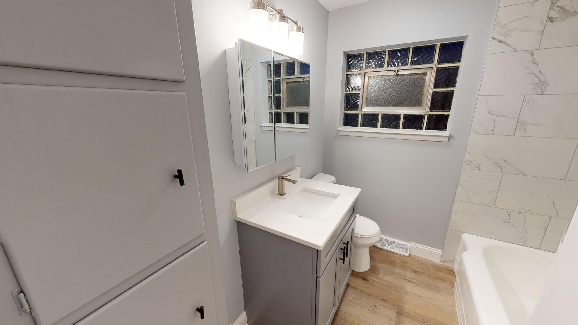 526 High Ridge Road Hillside, IL 60162 - Photo 11 of 19 a bathroom with a sink toilet and mirror