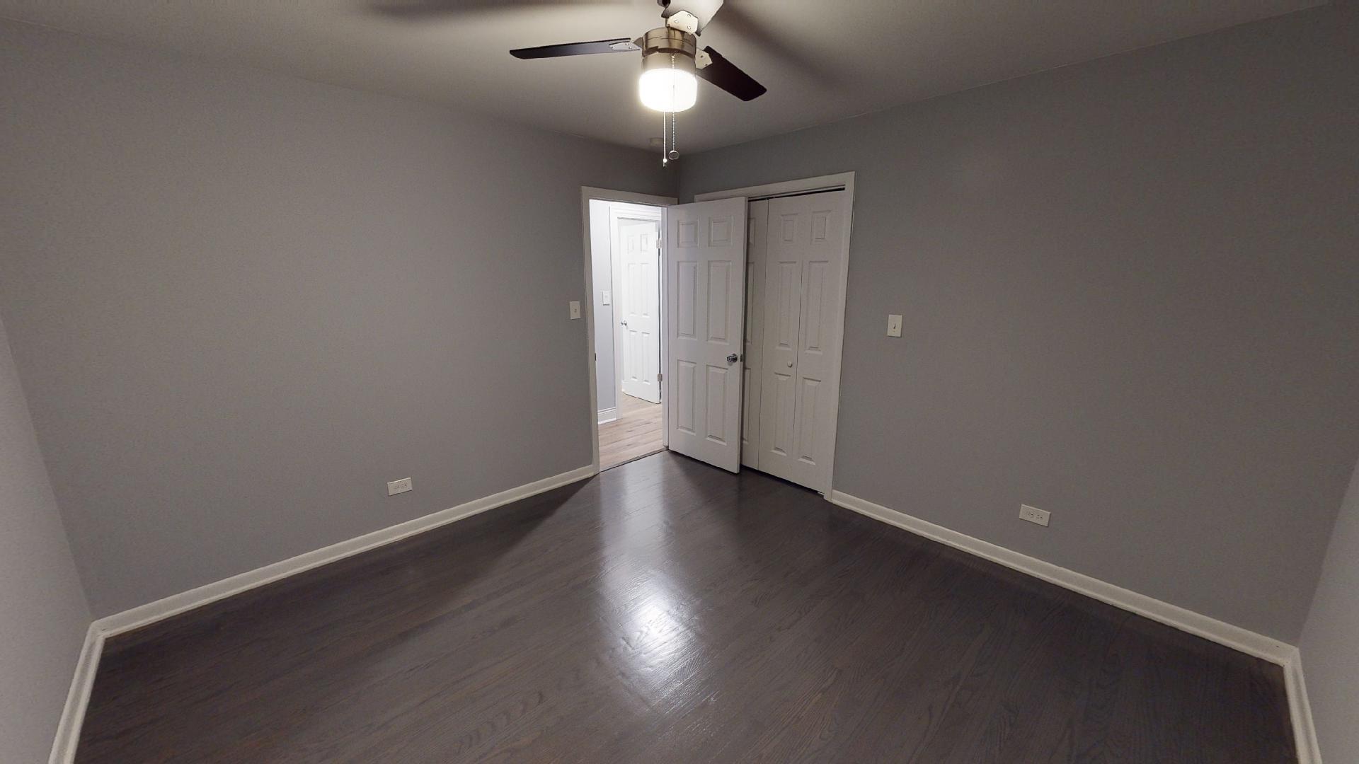 526 High Ridge Road Hillside, IL 60162 - Photo 12 of 19 a view of an empty room with wooden floor and a ceiling fan