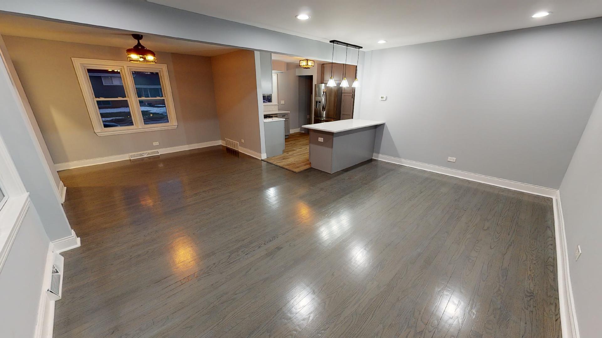 526 High Ridge Road Hillside, IL 60162 - Photo 3 of 19 a view of an empty room with wooden floor and windows