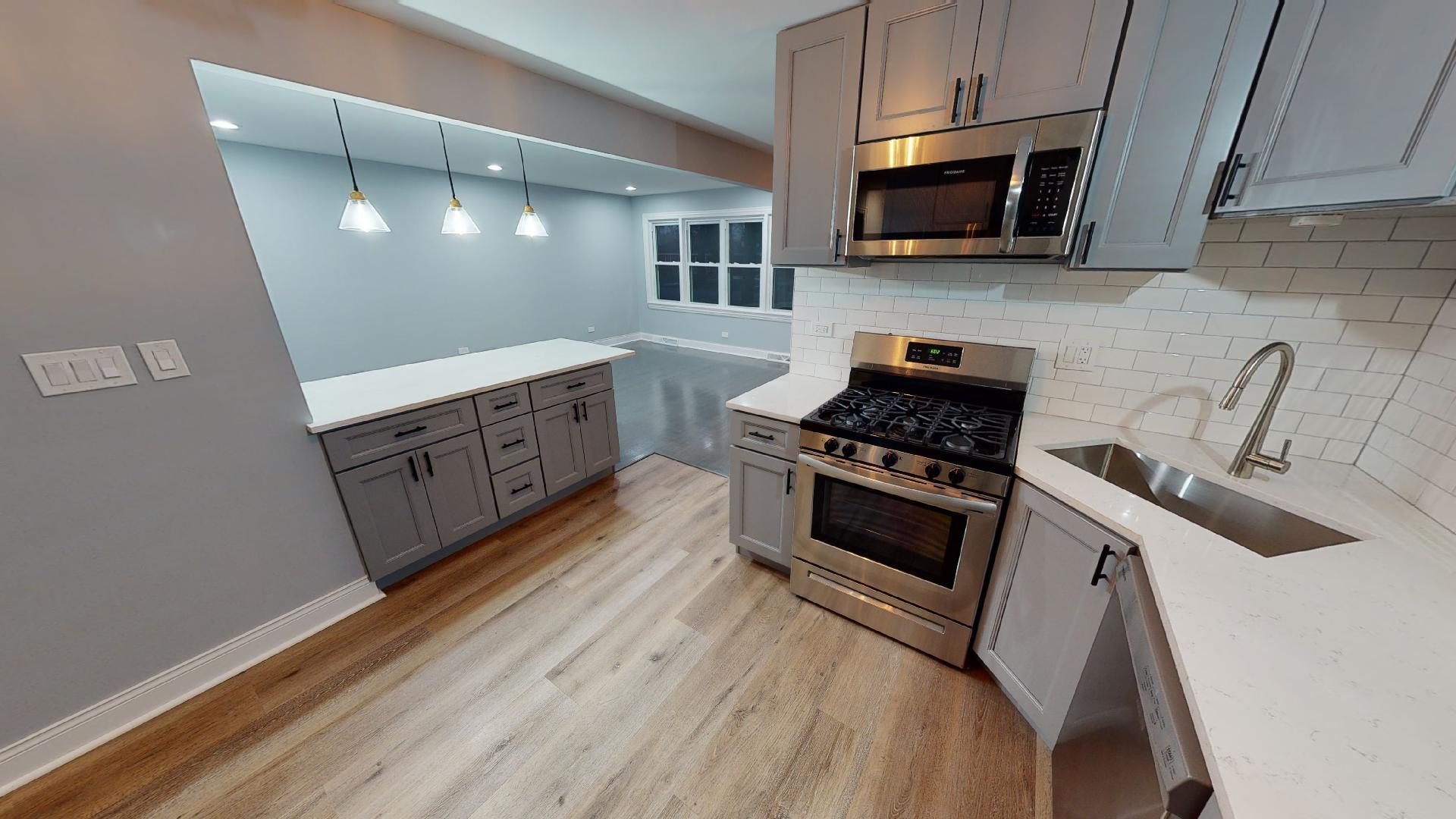 526 High Ridge Road Hillside, IL 60162 - Photo 5 of 19 a kitchen with granite countertop a stove and a microwave