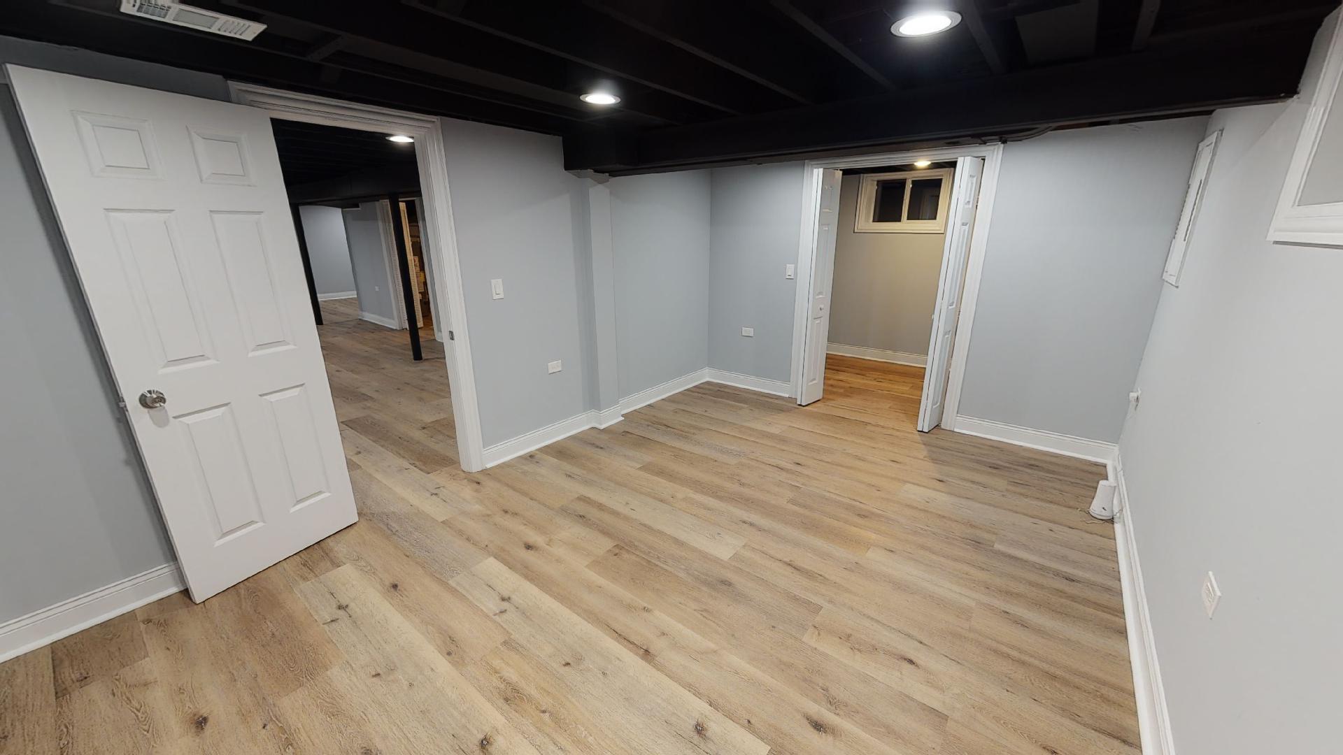 526 High Ridge Road Hillside, IL 60162 - Photo 7 of 19 an empty room with wooden floor and entrance