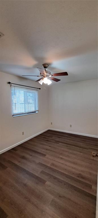 1715 Southwest 69 Way, Unit A Gainesville, FL 32607 - Photo 12 of 18 a view of an empty room with wooden floor and a window