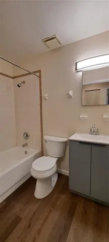 a bathroom with a toilet a sink and bathtub