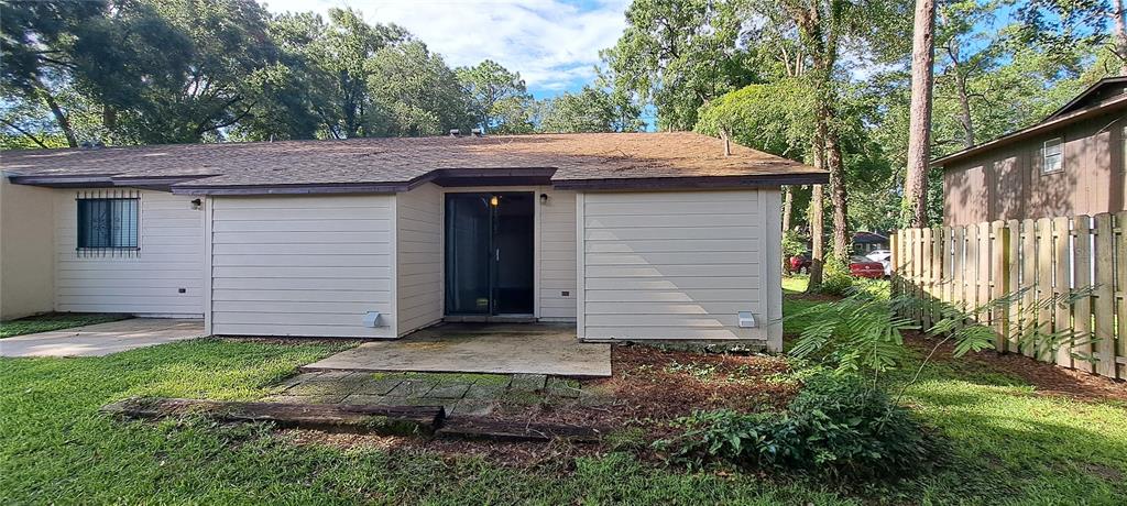 1715 Southwest 69 Way, Unit A Gainesville, FL 32607 - Photo 15 of 18 a view of a house with a small yard plants and large tree