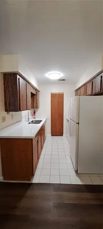 a kitchen with stainless steel appliances wooden cabinets and fireplace
