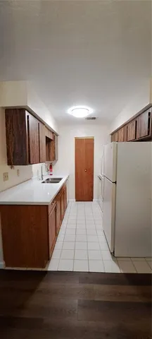 a kitchen with stainless steel appliances wooden cabinets and fireplace