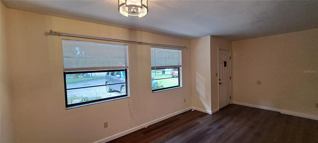 1715 Southwest 69 Way, Unit A Gainesville, FL 32607 - Photo 4 of 18 a view of an empty room with wooden floor and a window