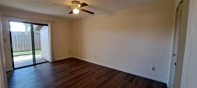 wooden floor in an empty room with a window