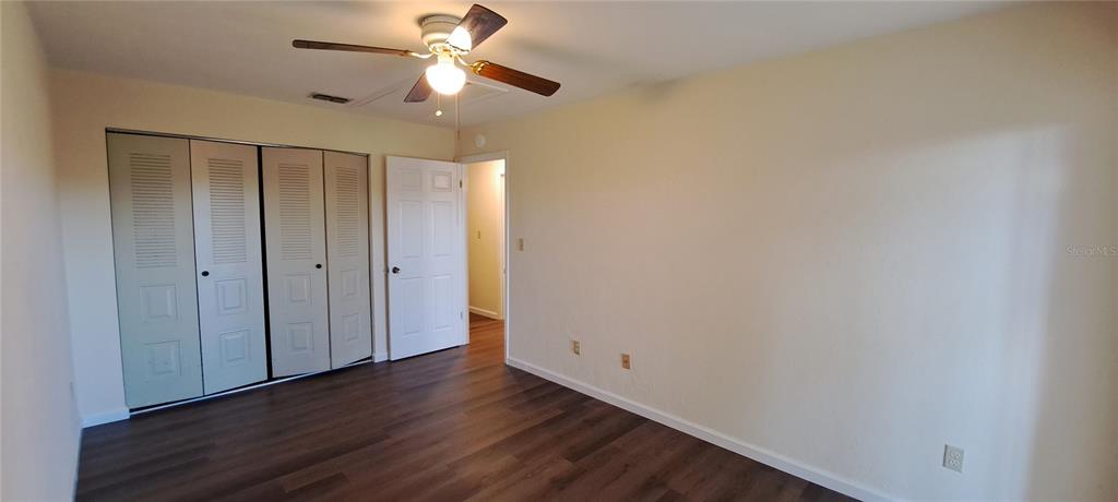 1715 Southwest 69 Way, Unit A Gainesville, FL 32607 - Photo 10 of 18 a view of room with hardwood floor and a ceiling fan