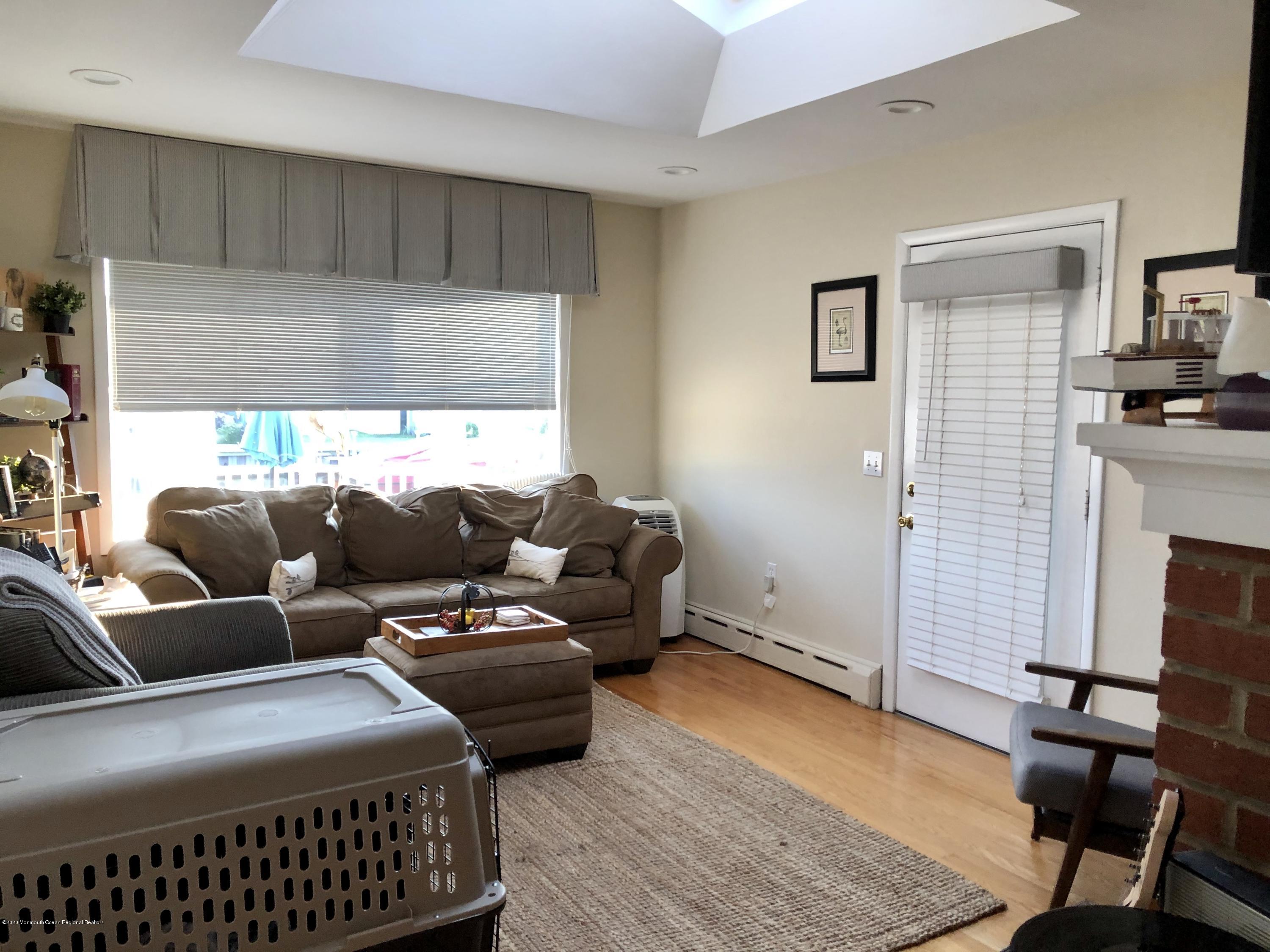 29 Mandalay Road Brick, NJ 08723 - Photo 7 of 13 a living room with furniture and a fireplace