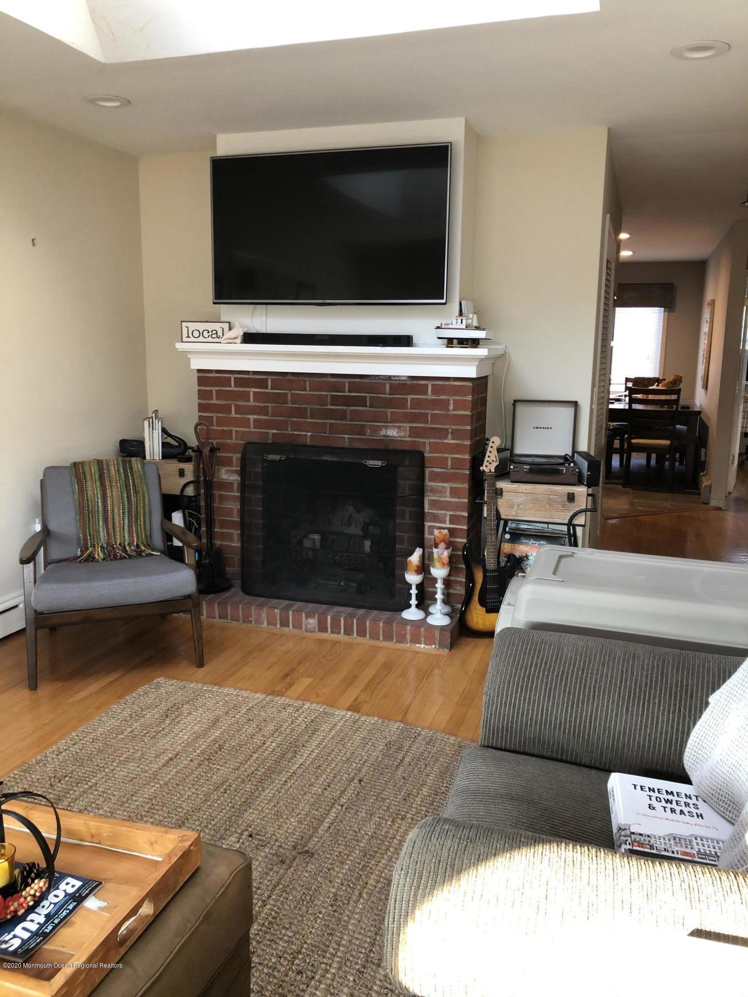 29 Mandalay Road Brick, NJ 08723 - Photo 8 of 13 a living room with furniture a flat screen tv and a fireplace