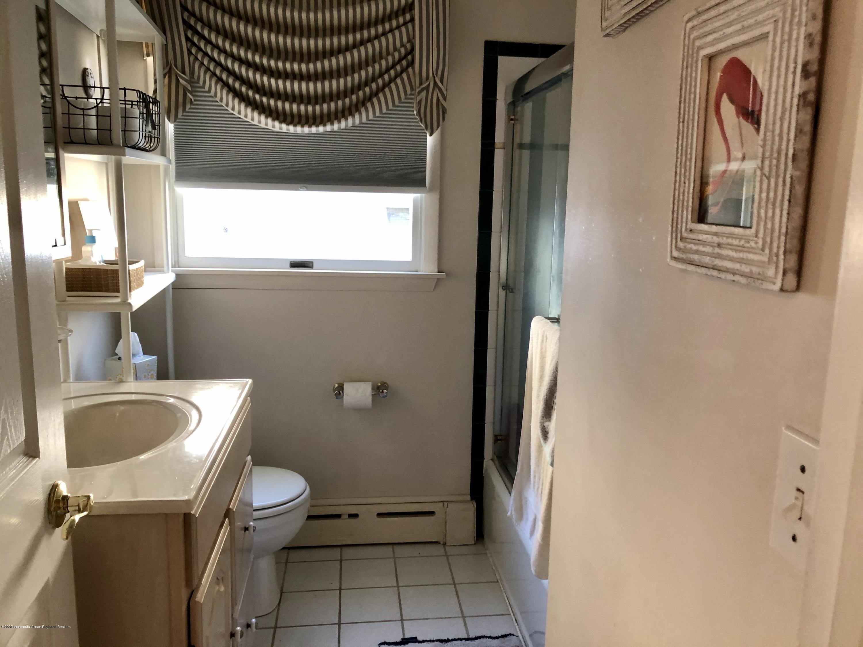 29 Mandalay Road Brick, NJ 08723 - Photo 10 of 13 a bathroom with a sink a toilet and a mirror