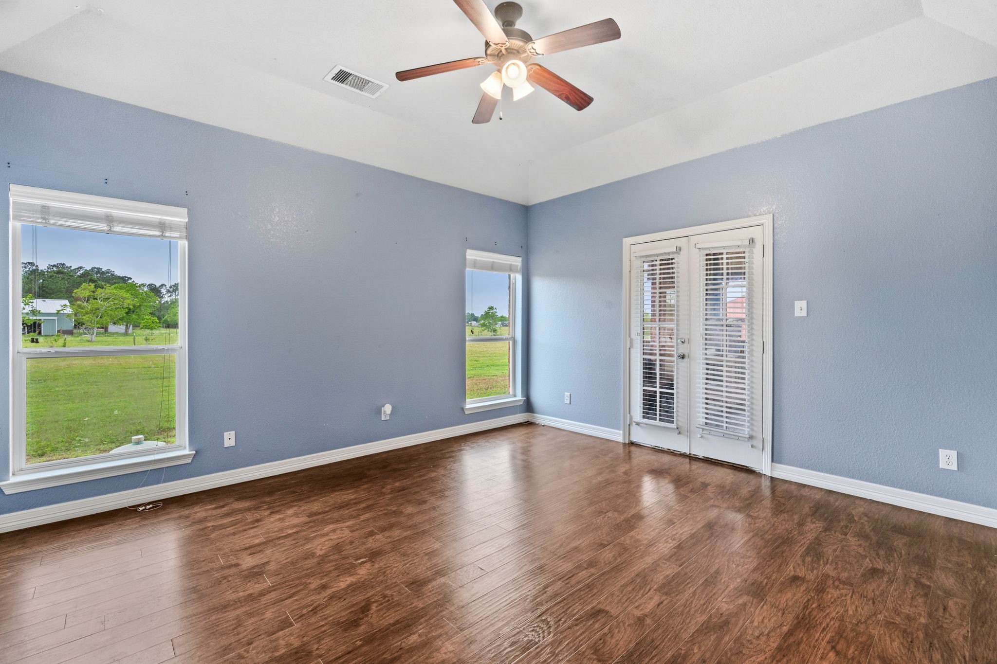1405 Big Hill Road Winnie, TX 77665 - Photo 32 of 43 a view of an empty room with window and wooden floor