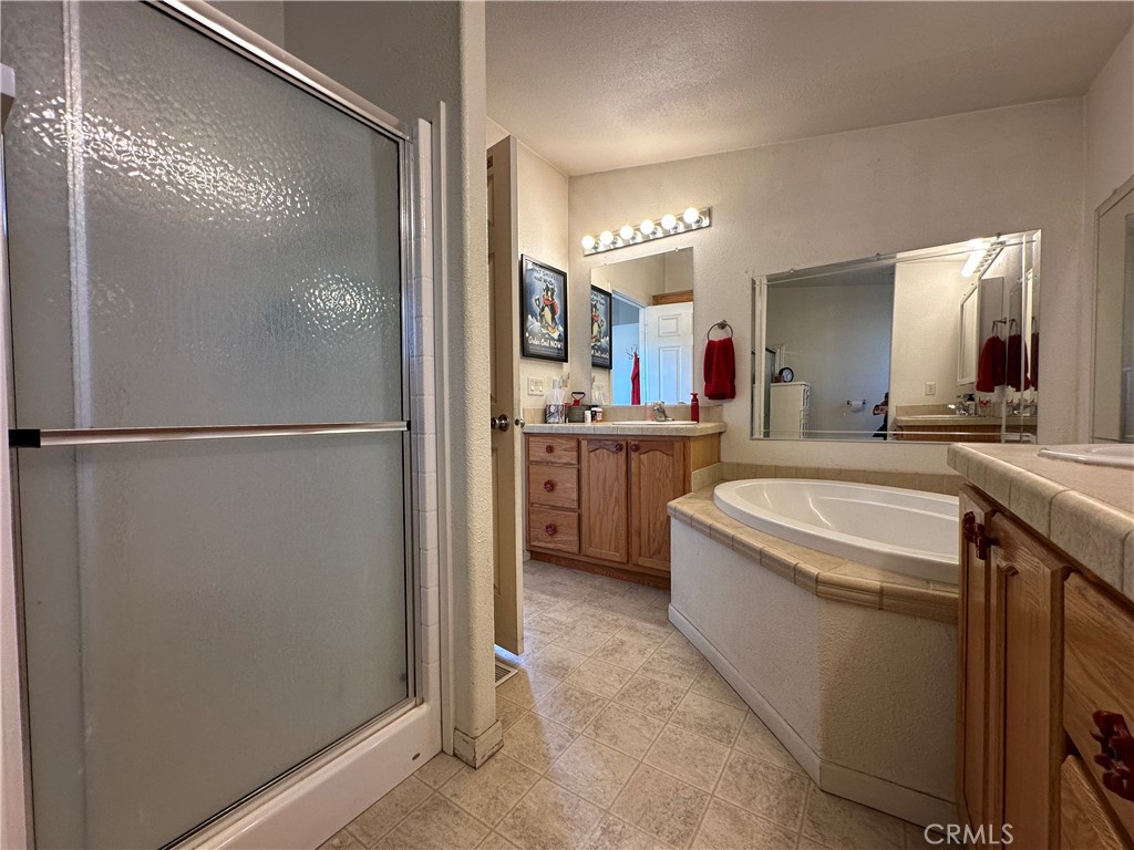 29820 Chihuahua Valley Road Warner Springs, CA 92086 - Photo 61 of 75 a spacious bathroom with a granite countertop sink mirror and a bathtub
