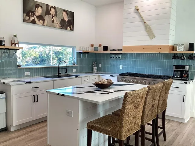 a kitchen with a table chairs and cabinets