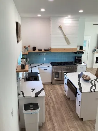 a kitchen with a sink and wooden floor