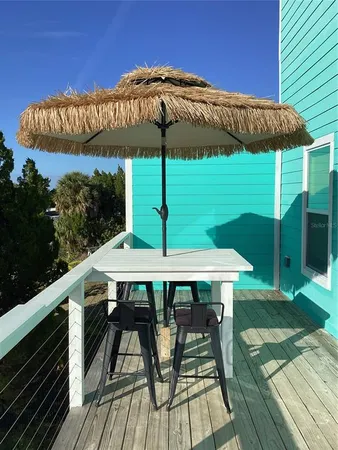 a view of balcony with table and chairs