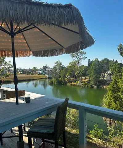 a view of a lake from a balcony with outdoor space