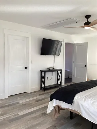 a bedroom with a bed and a flat screen tv