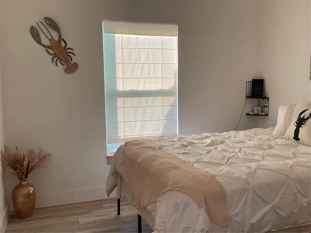 a bedroom with a bed and a potted plant