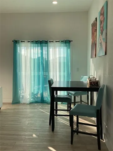 a view of a dining room with furniture and window