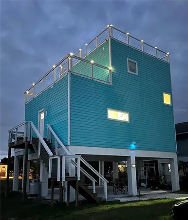 a front view of house along trees