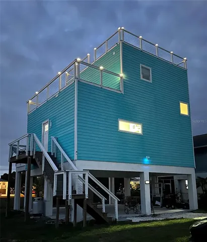 a front view of house along trees