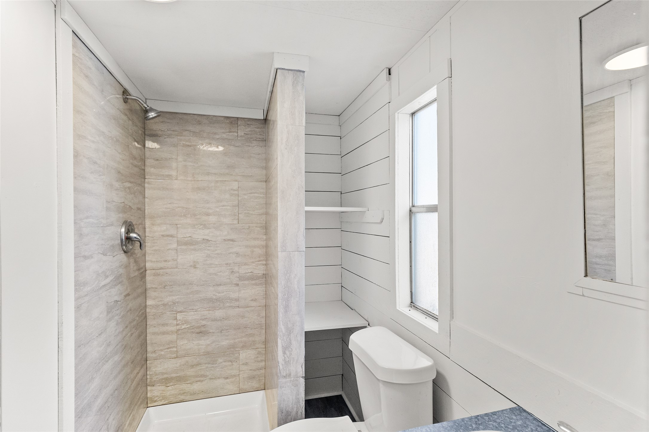 1202 Highway 190, Unit 16 Huntsville, TX 77340 - Photo 12 of 23 a bathroom with a toilet and a shower