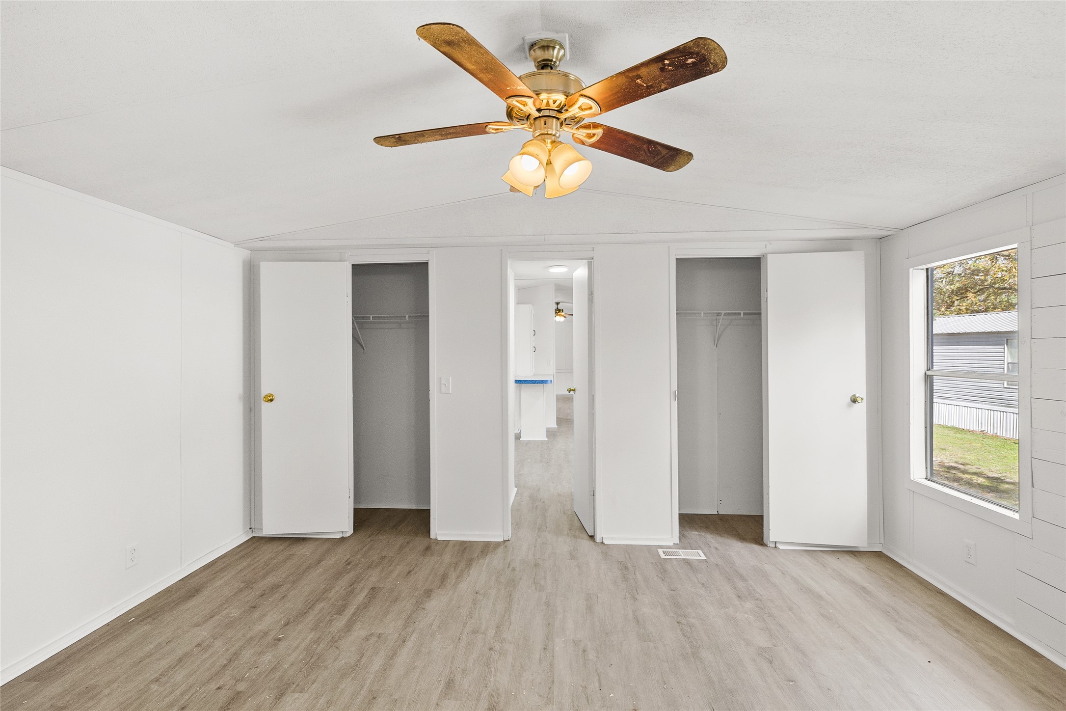 1202 Highway 190, Unit 16 Huntsville, TX 77340 - Photo 14 of 23 a view of an empty room with window and wooden floor