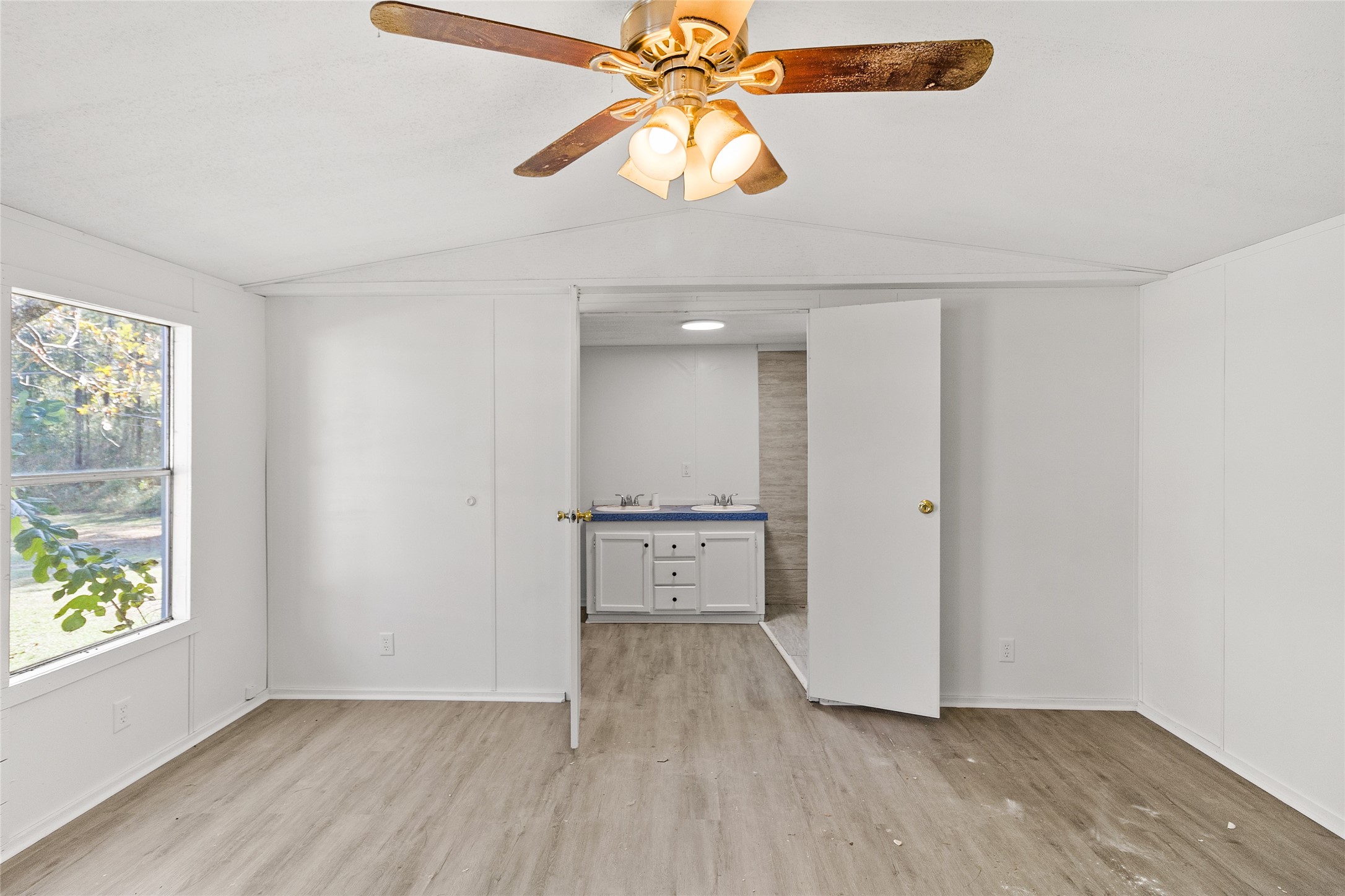 1202 Highway 190, Unit 16 Huntsville, TX 77340 - Photo 15 of 23 wooden floor in an empty room with a window