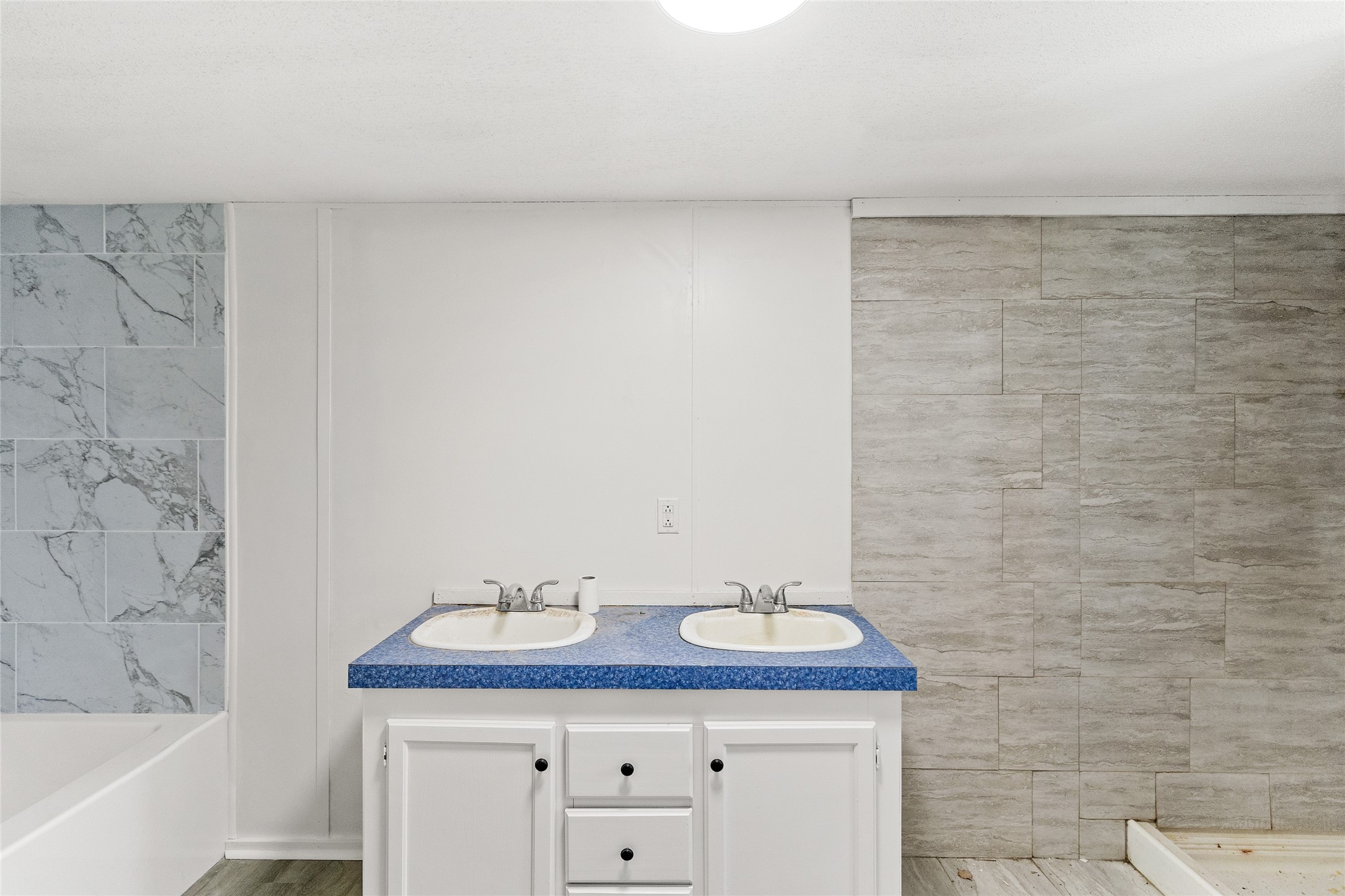 1202 Highway 190, Unit 16 Huntsville, TX 77340 - Photo 16 of 23 a bathroom with a granite countertop sink and a mirror