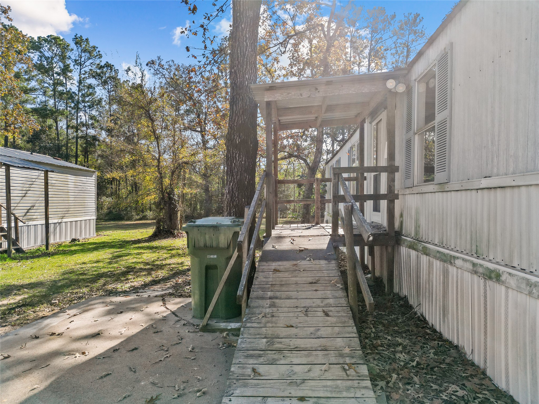 1202 Highway 190, Unit 16 Huntsville, TX 77340 - Photo 2 of 23 a view of a porch with furniture and garden
