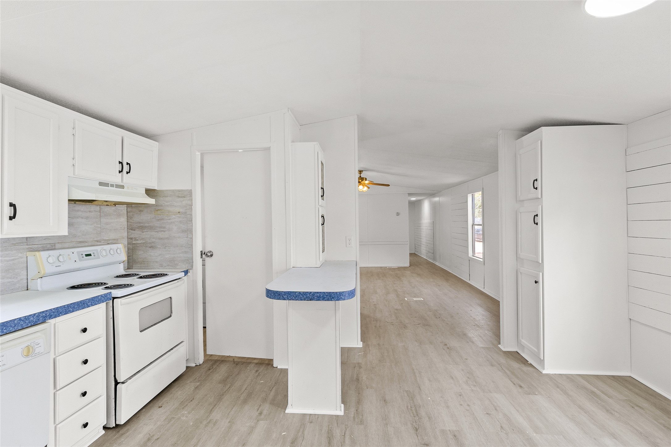 1202 Highway 190, Unit 16 Huntsville, TX 77340 - Photo 6 of 23 a kitchen with white cabinets and white appliances