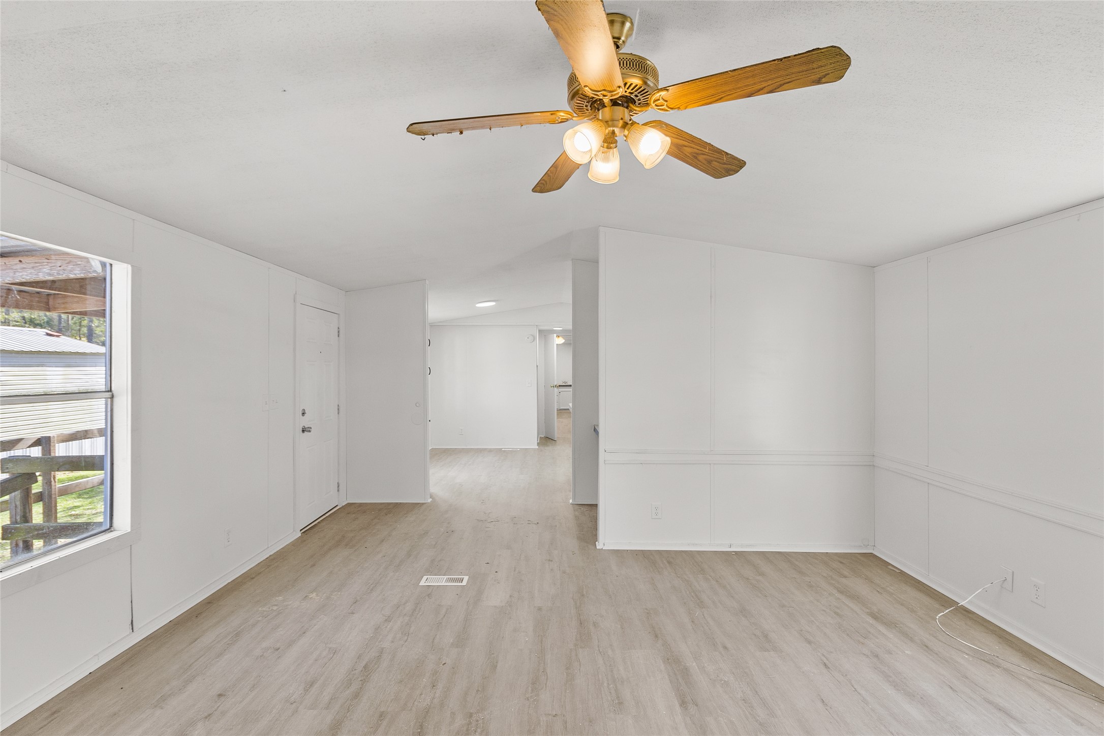 1202 Highway 190, Unit 16 Huntsville, TX 77340 - Photo 8 of 23 an empty room with wooden floor fan and windows