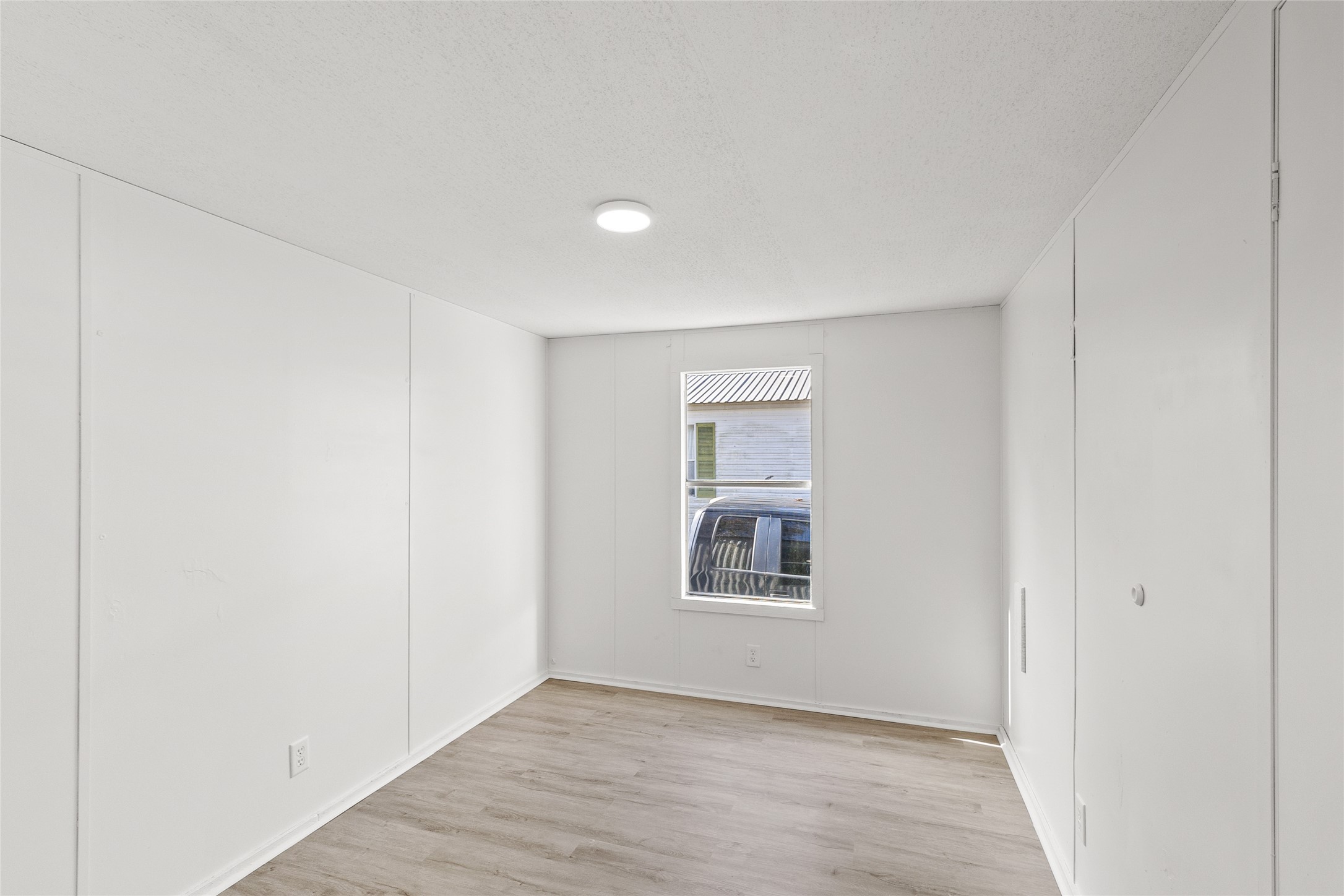 1202 Highway 190, Unit 16 Huntsville, TX 77340 - Photo 10 of 23 an empty room with windows and closet
