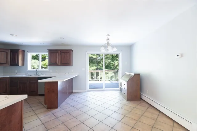 a kitchen with stainless steel appliances kitchen island granite countertop a sink and a stove